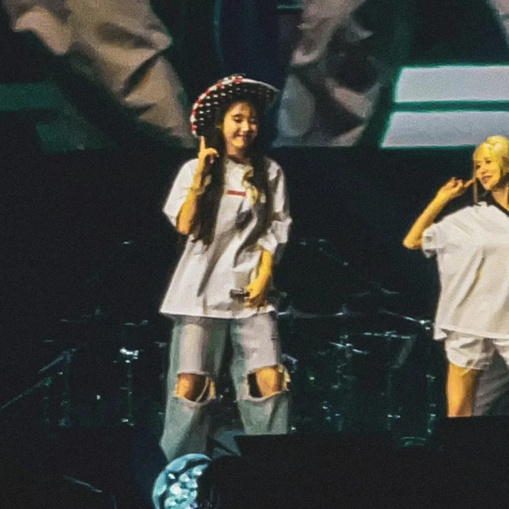 IU performing on stage at a concert in Los Angeles